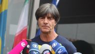 Germany's head coach Joachim Loew talks to media as he arrives at Frankfurt international airport on June 28, 2018, after flying back from Moscow following the German national football team's defeat in the Russia 2018 football World Cup. (AFP / Daniel ROL