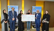 Dr R Seetharaman (second right), CEO of Doha Bank, with other officials of the bank and winners of the fourth draw of Al Dana Savings Scheme, at the bank’s branch in Dar Al Salam Mall.