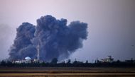 Smoke rises above rebel-held areas of the city of Saida, some 10 kilometers east of Daraa, during reported airstrikes by Syrian regime forces on July 4, 2018. AFP / Mohamad Abazeed