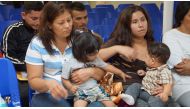 In this file photo taken on June 15, 2018 Mothers and children wait to be assisted by volunteers in a humanitarian center in the border town of McAllen, Texas. AFP / Leila Macor 
 

