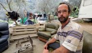 Cedric Herrou, a French farmer and volunteer assisting migrants to cross the French-Italian border to avoid police controls, poses as he sits in a couch near tents for migrants pitched at his land in Breil-sur-Roya, France, April 11, 2017.  Reuters/Eric G