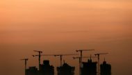 Cranes stand above an apartment complex under construction in Singapore May 15, 2013. Reuters/Tim Wimborne
