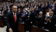 Turkey's President Tayyip Erdogan leaves his seat to address members of parliament from his ruling AK Party (AKP) at the Turkish parliament in Ankara, Turkey, July 7, 2018. REUTERS/Umit Bektas