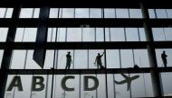 Workers clean the windows in the departure area at Vienna's airport in Schwechat April 2, 2014. Reuters/Leonhard Foeger