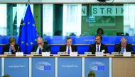 European Central Bank (ECB) President Mario Draghi (C) delivers a speech during a meeting of the Committee on economic and monetary affairs (ECON) at the European Parliament, in Brussels, on July 9, 2018, in front of signs reading 