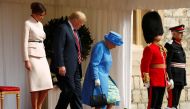 The First Lady Melania Trump waits as U.S. President Donald Trump and Britain's Queen Elizabeth walk across the courtyard to inspect the Coldstream Guards during a visit to Windsor Castle in Windsor, Britain, July 13, 2018. Reuters/Kevin Lamarque

