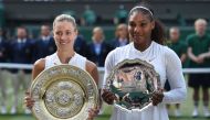 Germany's Angelique Kerber (L) holds the winner's trophy, the Venus Rosewater Dish, after her women's singles final victory over US player Serena Williams on the twelfth day of the 2018 Wimbledon Championships at The All England Lawn Tennis Club in Wimble