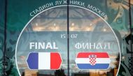 A fan poses for a photo in front of 2018 FIFA World Cup museum's wall ahead of the final match of the 2018 FIFA World Cup between France and Croatia at Luzhniki Stadium in Moscow, Russia on July 14, 2018. ( ?ebnem Co?kun - Anadolu Agency )