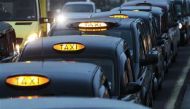 Black taxi cabs queue at a taxi rank near Paddington Station, in London. REUTERS/Luke MacGregor/File photo
