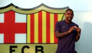 Brazilian soccer player Malcom Filipe Silva de Oliveira poses in front of a FC Barcelona logo at their offices next to Camp Nou stadium in Barcelona, Spain July 24, 2018. REUTERS/Albert Gea