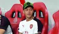 Mesut Ozil of Arsenal sits at the players bench during a match against Atletico Madrid at the International Champions Cup match in Singapore on July 26, 2018. AFP / Roslan Rahman