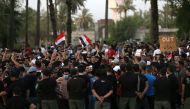 Iraqi security forces stand guard during a protest at Tahrir square in Baghdad, Iraq July 27, 2018. REUTERS/Thaier al-Sudani