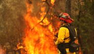 A Redding firefighter looks on as the Carr Fire moves through the area on July 28, 2018 in Redding, California. Justin Sullivan/Getty Images/AFP