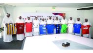 QNB Stars League team officials pose for a photograph with their playing jerseys during a technical meeting held at Al Bidda Tower yesterday. 