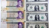 Iran rial banknotes next to US one-Dollar bills at a currency exchange office in Tehran, on April 10, 2018 (AFP / Atta Kenare) 