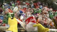 A worker removes labels from recycled plastic bottles to be used in the construction of the sailboat Plastiki at Pier 31 in San Francisco, California, March 13, 2009. (Reuters / Robert Galbraith)