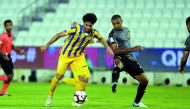 Al Gharafa’s Ahmed Alaaeldin Abdlmotaal (left) and Sandro Ferreira Nascimento of Qatar SC vie for the ball possession during their QNB Stars League (QSL) match at Al Sadd Stadium yesterday. 
Pic: Abdul Basit/The Peninsula