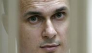Ukrainian film director Oleg Sentsov looking on inside a defendants' cage during a hearing at a military court in the city of Rostov-on-Don on July 22, 2015. AFP / Sergei Venyavsky

