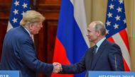 Donald Trump and Vladimir Putin shake hands before attending a joint press conference after a meeting at the Presidential Palace in Helsinki on July 16, 2018 (AFP / Yuri Kadobnov) 
