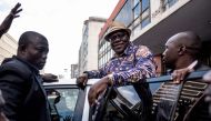 Former Zimbabwean Finance Minister and MDC Alliance member Tendai Biti greets supporters outside the MDC Alliance's headquarters in Harare on July 31, 2018. AFP / Marco Longari
 