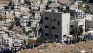 Security forces gather near a damaged building at the city of Salt, Jordan, August 12, 2018. (REUTERS/Muhammad Hamed)