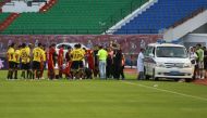 This photo taken on August 11, 2018 shows Wang Shouting (C-on ground), a player for Chinese club Changchun Yatai, receiving medical attention after an injury as medical staff (R) try to open the door of an ambulance during their Chinese Super League footb