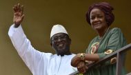 Malian Opposition leader and presidential candidate SoumaIila Cisse and his wife Astan Traore waves to supporters in the front of his residence on August 13, 2018 in Bamako a day after the runoff vote in Mali's presidential election.  AFP / Issouf Sanogo 
