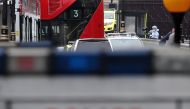 Police forensics officers work at the scene (top R) outside the Houses of Parliament in central London on August 14, 2018, where a car was driven into the barriers. / AFP / Daniel LEAL-OLIVAS