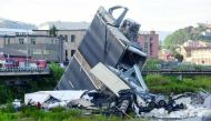 The collapsed Morandi Bridge is seen in the Italian port city of Genoa, Italy August 14, 2018. Reuters/Massimo Pinca 