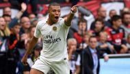Paris Saint-Germain's French forward Kylian Mbappe celebrates after scoring their third goal during the French L1 football match between Guingamp and Paris Saint-Germain, at the Roudourou stadium in Guingamp on August 18, 2018. (AFP / FRED TANNEAU)