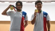 Gold medallists Taiwan's Lin Yingshin (L) and Lu Shaochuan pose with their medals during the victory ceremony for the 10m air rifle mixed team shooting final during the 2018 Asian Games in Palembang on August 19, 2018. / AFP / Mohd RASFAN 