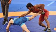 India's Bajrang Bajrang (R) competes with Mongolia's Batmagnai Batchuluun in the men's wrestling freestyle 65kg semi-final at the 2018 Asian Games in Jakarta on August 19, 2018. (AFP / AAMIR QURESHI)