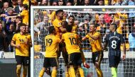 Wolverhampton Wanderers' French defender Willy Boly (C) celebrates with team-mates after scoring the opening goal during the English Premier League football match between Wolverhampton Wanderers and Manchester City at the Molineux stadium in Wolverhampton