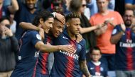 Paris Saint-Germain's French forward Kylian Mbappe (C) is congratulated by Paris Saint-Germain's Brazilian forward Neymar (R) and Paris Saint-Germain's Uruguayan forward Edinson Cavani (L) after scoring a goal during the French L1 football match Paris Sai