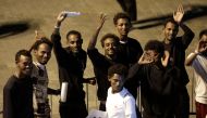  Migrants wave after disembarking from Italian coast guard vessel 