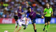 Real Valladolid's Spanish defender Javi Moyano (L) falls beside Barcelona's Brazilian midfielder Philippe Coutinho during the Spanish league football match between Real Valladolid and FC Barcelona at the Jose Zorrilla Stadium in Valladolid on August 25, 2