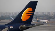 :FILE PHOTO: A Jet Airways plane is parked as other moves to runway at the Chhatrapati Shivaji International airport in Mumbai, India, February 14, 2018. REUTERS/Danish Siddiqui