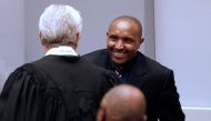 Former Congolese warlord Bosco Ntaganda (R) arrives at the courtroom of the International Criminal Court (ICC) during the closing statements of his trial in the Hague, the Netherlands, on August 28, 2018.  AFP / Bas Czerwinski
