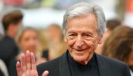 Greek-French director Costa-Gavras waves as he arrives for the screening of the tv series 'Twin Peaks' at the 70th edition of the Cannes Film Festival on May 25, 2017, in Cannes, southern France.  AFP / Loic Venance 