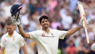 (FILES) In this file photo taken on December 28, 2017 England's batsman Alastair Cook (R) celebrates scoring his double century against Australia on the third day of the fourth Ashes cricket Test match at the MCG in Melbourne. AFP / WILLIAM WEST