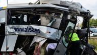 A civil guard surveys the wreckage of a bus crash which left at least four people dead in Aviles, Spain, September 3, 2018. REUTERS/Eloy Alonso