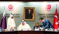 H E Sheikh Ahmed bin Jassim Al Thani (sitting left), Minister of Economy and Commerce, and his Turkish counterpart Ruhsar Pekcan, Minister of Trade of the Republic of Turkey, signing the documents of the agreement in Ankara, yesterday. 