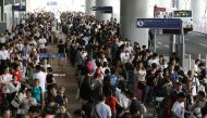 Passengers stranded overnight at the Kansai International Airport due to typhoon Jebi queue for buses that will transport them from the airport in Izumisano city, Osaka prefecture on September 5, 2018. AFP / JIJI PRESS / JIJI PRESS