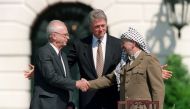  In this file photo taken on September 13, 1993 US President Bill Clinton (C) stands between PLO leader Yasser Arafat (R) and Israeli Prime Minister Yitzahk Rabin (L) as they shake hands for the first time, at the White House in Washington DC, after signi