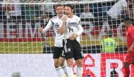 Germany's defender Nico Schulz (R) and Germany's forward Thomas Mueller celebrate scoring during the international friendly football match Germany vs Peru at the Rhein-Neckar-Arena in Sinsheim, southwestern Germany, on September 9, 2018. 