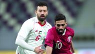 Qatari forward and captain Hasan Al Haydos (right) vies for the ball against Palestine’s Shadi Shaban during their friendly football match played at the Khalifa International Stadium in Doha yesterday. 