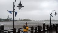 A man walks along the river front as heavy rain from Hurricane Florence falls in Wilmington, North Carolina on September 14, 2018. AFP / Andrew Caballero-Reynolds