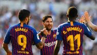 Barcelona's French forward Ousmane Dembele (R) celebrates with Barcelona's Argentinian forward Lionel Messi and Barcelona's Uruguayan forward Luis Suarez after scoring a goal during the Spanish league football match between Real Sociedad and FC Barcelona 