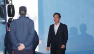 File photo of Samsung heir Lee Jae-Yong (R) walks out from a court in Seoul on February 5, 2018, after an appellate court handed him a suspended sentence. / AFP / Dong-A Ilbo / 