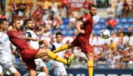 Roma's Italian midfielder Bryan Cristante (R) and Roma's Bosnian forward Edin Dzeko (2ndL) go for the ball during the Italian Serie A football match AS Rome vs Chievo Verona on September 16, 2018 at the Olympic stadium in Rome. / AFP / Alberto PIZZOLI